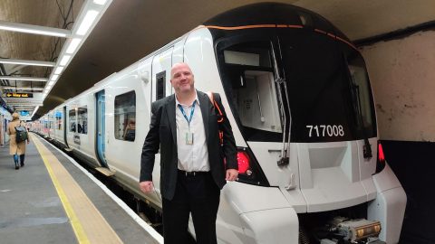 Driver Mark Webb in front of one of the first trains to run in passenger service digital in-cab signalling on the platform in front of the train