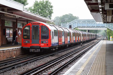 Image of London Underground train in the open air at Theydon Bois station. Deep level 1992 stock from the Central Line