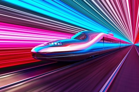 High-speed train speeds through a pink and blue neon-lit futuristic tunnel.