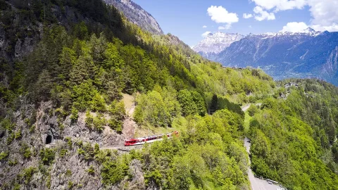 The Mont Blanc express in a mountain view, exiting a rail tunnel