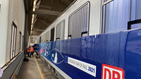 A train is being fitted with FleetShield wrapping