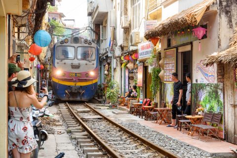The famous Hanoi train street, where a train runs through a very narrow street.